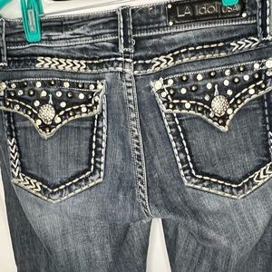 LA Idol Boot Cut Jeans. Bejeweled back pockets with contrast stictching